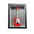 Red electric guitar model in a black frame on a white background